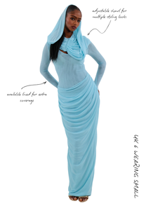 Model in icy blue modest draped maxi dress with detachable shawl styled over the head.